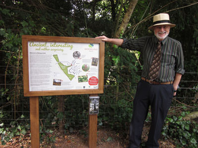 Bev Knott, Chairman of Friends of Bishop’s Knoll Wood, with a new information board featuring AGT logo